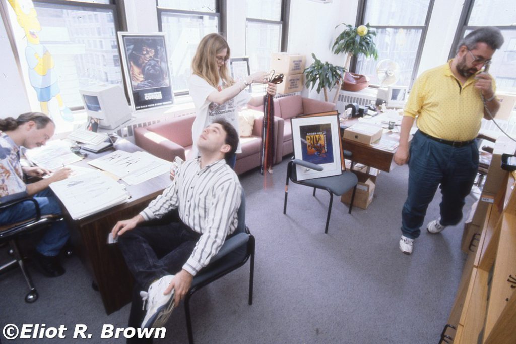 One of my favorite pictures ever of the Marvel offices in 1992. A minor “Night at the Opera stateroom scene” featuring a pony-tailed Executive Editor Mark Gruenwald, then-Assistant Editor David Wohl, Tom’s Executive Secretary Mary “Mac” McPherran and Editor In Chief Tom DeFalco. This was during the roughly 2-month period that Marvel Comics Editorial was moved, lock, stock and comic book down to the 4th Floor of 387 Park. The 10th Floor offices were being completely remodeled for about that long. The “corner office” was one of the nicer offices ever for a Marvel editorial team—mostly because the office that was to come, up on 10, was in the same corner-window position but not as large. Formerly, that spot had been taken by the Publisher (Michael Z. Hobson) and the room ended at the third window on the left.